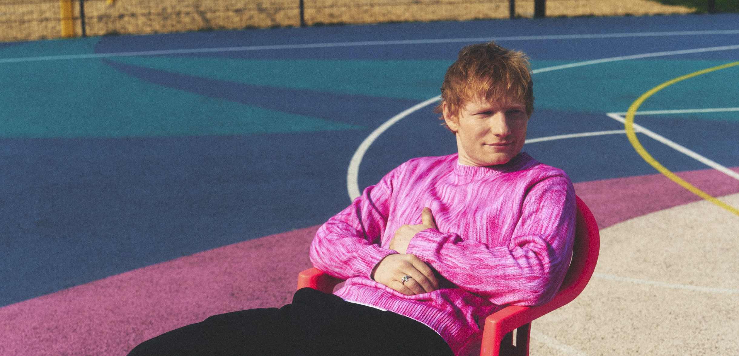 Ed sitting in a chair on a tennis court